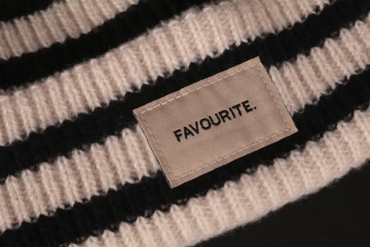 Woven and embroidered fabric label detail